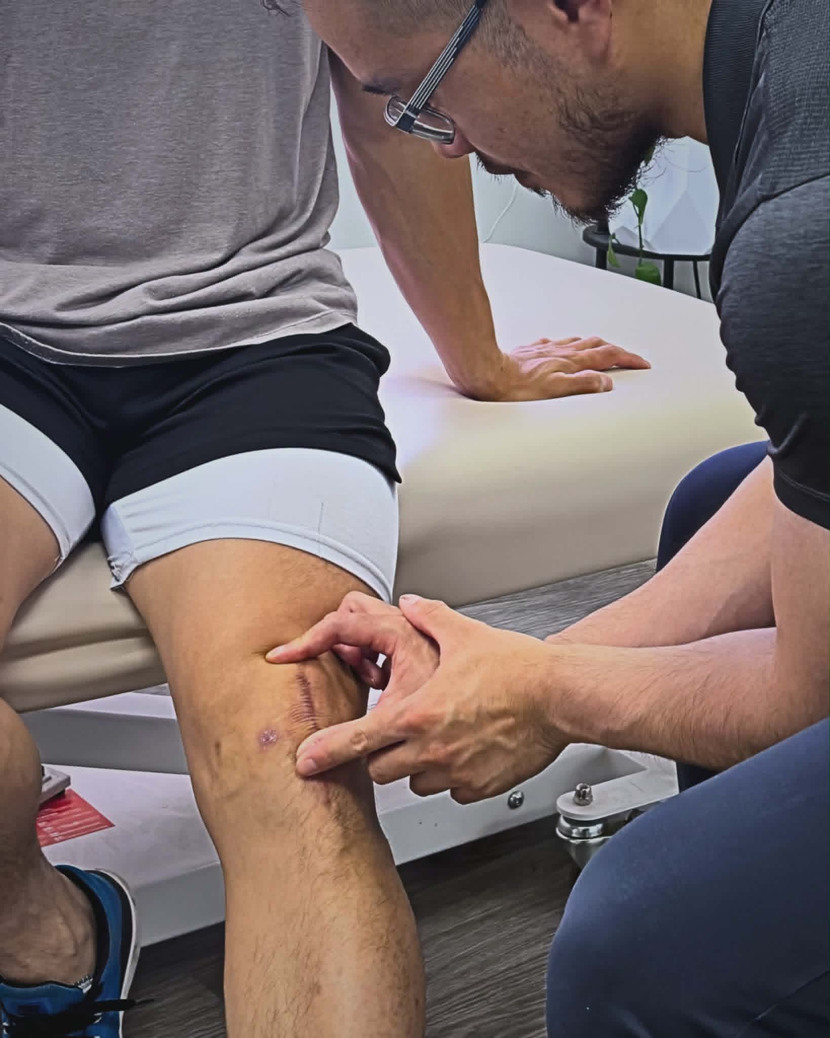 Pat Wu assessing a post-surgical knee scar