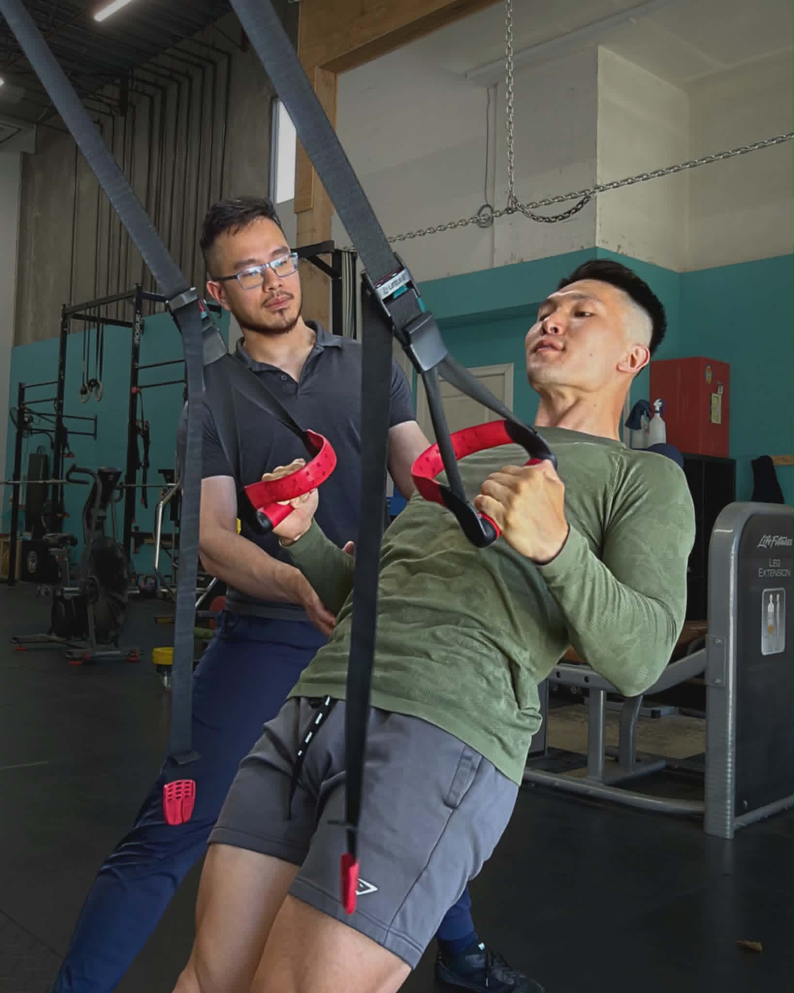 Pat Wu coaching a patient through a strength exercise
